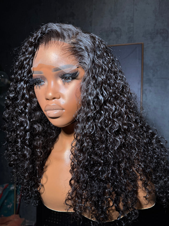 Mannequin with long, curly hair in a dark room